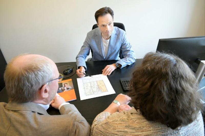Advisor reviewing plans with a couple at a desk